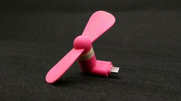 Portable USB pink fan isolated photo