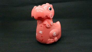 Pink dinosaur toy isolated photo