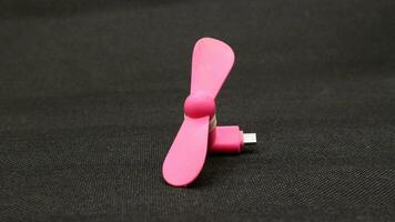 Portable USB pink fan isolated photo