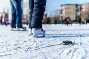 hockey puck lies on the snow macro photo