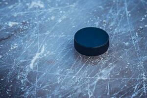 hockey puck lies on the snow macro photo