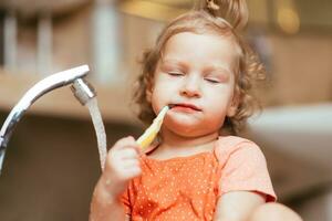 Cheerful happy child brushes his teeth in the morning in the bath photo