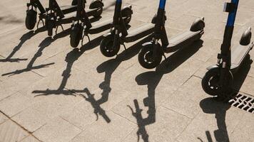 Electric scooters are parked in the city center. Modern public mobile transport photo