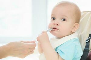 mother feeding her baby breast porridge day photo