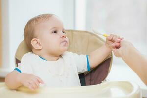 mother feeding her baby breast porridge day photo