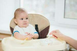 mother feeding her baby breast porridge day photo