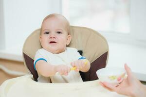 mother feeding her baby breast porridge day photo