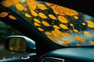 Autumn leaves and raindrops on the windshield of a car. Inside view. selective focus. generative ai. photo