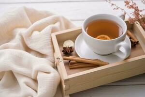 Tea tray and sweater, white wood background, toned. generative ai. photo