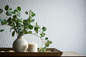 Beautiful burning candles with green leaves in vase on white table. generative ai. photo