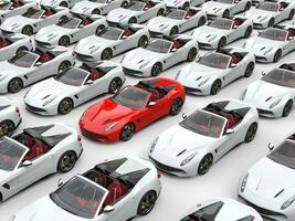 Awesome red sports car stands out in the middle of the field of white cars photo