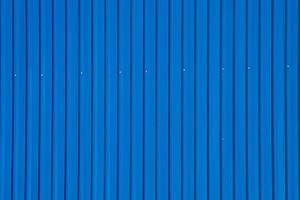 blue corrugated metal roof with rivets, industrial background photo