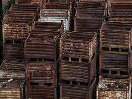 Stacks of discarded rusty metal storage boxes photo