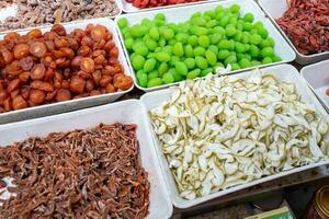 Sacks of dried fruit and candy in Da Lat market, Vietnam. photo