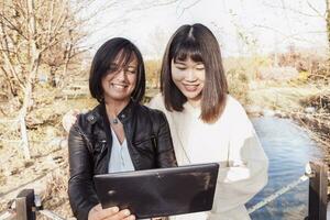 multi-ethnic co-worker couple playing with a digital tablet photo