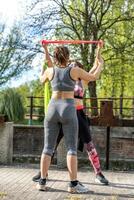 beautiful mature women doing exercises outdoors with a resistance band photo