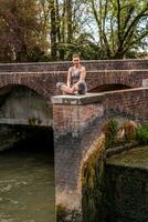 beautiful mature woman taking a relaxing moment on a brick deck outdoors photo