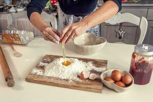 woman in the kitchen while mixing the dough photo