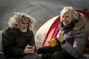 beautiful mature couple relaxing and drinking hot coffee photo