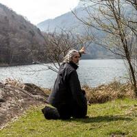 mature man practicing Tai Chi discipline outdoors photo