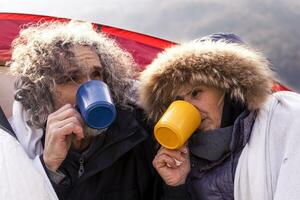 beautiful mature couple relaxing and drinking hot coffee photo