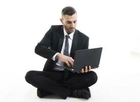 portrait of young businessman with laptop isolated on white background photo