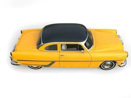 Beautiful old school yellow car with black roof - top down side view photo