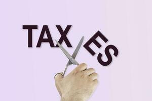 Scissors cutting the word taxes photo