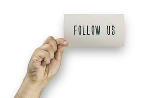 Follow us. Concept card hold by hand photo