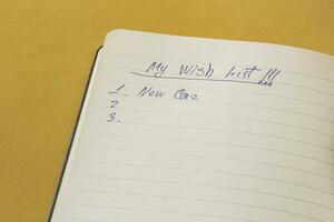 Notebook with wish list. Wonder list. New plans for new year photo