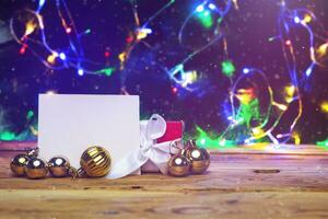 Beautiful Christmas background with copy space. New Year holidays. Christmas holidays. Cozy Christmas mood in home. Xmas decorations with blank card on the wooden background photo