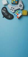 Gaming background. Video console and board games elements on bright blue background. Miscellaneous gaming pieces photo