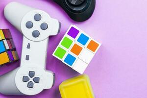 Gaming background. Video console and board games elements on bright pink background. Miscellaneous gaming pieces photo