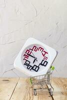 Buying time. Buy few more hours. A clock in shopping cart. purchase time photo