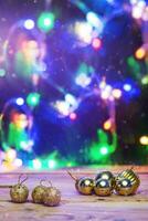 Christmas toys on wooden table against the decorated Christmas Tree. Xmas festive decorations on wood. Holiday background image photo