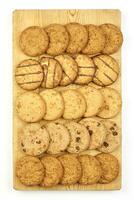 Sweet cookies on wooden cutting board photo