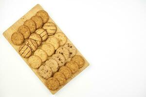 Sweet cookies on wooden cutting board photo