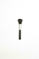 A makeup brush on white photo