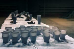 Snacks for drinking beer. Table served with plastic cups and bowls of appetizing croutons. photo