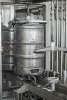 Beer kegs on the production line in the factory photo