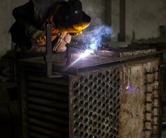 Welder working with metal photo