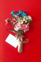 Bouquet of flowers with a card photo