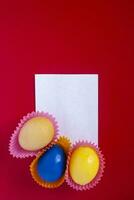 Decorated colorful easter eggs with empty piece of paper photo