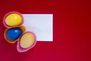 Decorated colorful easter eggs with empty piece of paper photo