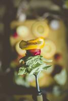 Hand holding fresh organic salad in fork photo