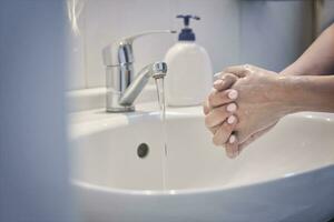 Woman washing hands photo