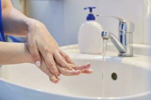 Woman washing hands photo