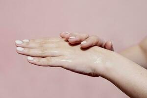 Woman using hand sanitizer. Importance of personal hygiene during pandemic photo