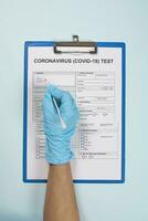 Doctor filling medical form for coronavirus test photo
