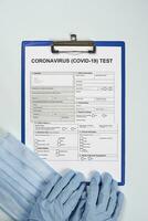 Doctor filling medical form for coronavirus test photo